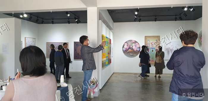 관람객들이 면천읍성안 미술 전시회장에서 작품을 감상하고 있다.