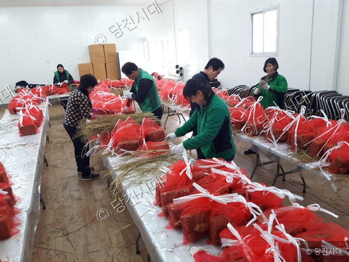 당진시새마을부녀회원들이 실내에서 메주를 포장하고 있다.