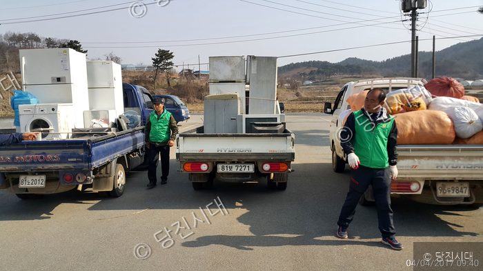 새마을운동 회원들이 트럭에 재활용품을 싣고 있다.