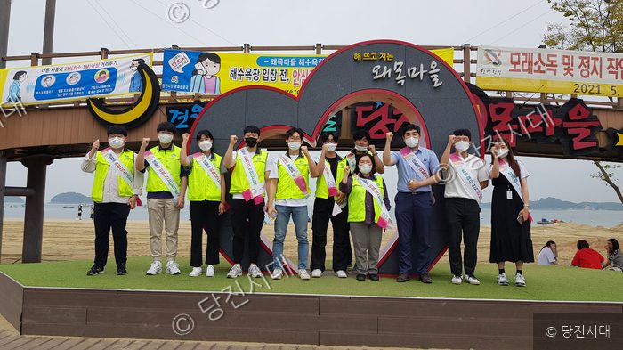 봉사자들이 왜목마을 해수욕장에서 안전점검 봉사활동 기념촬영을 하고 있다.