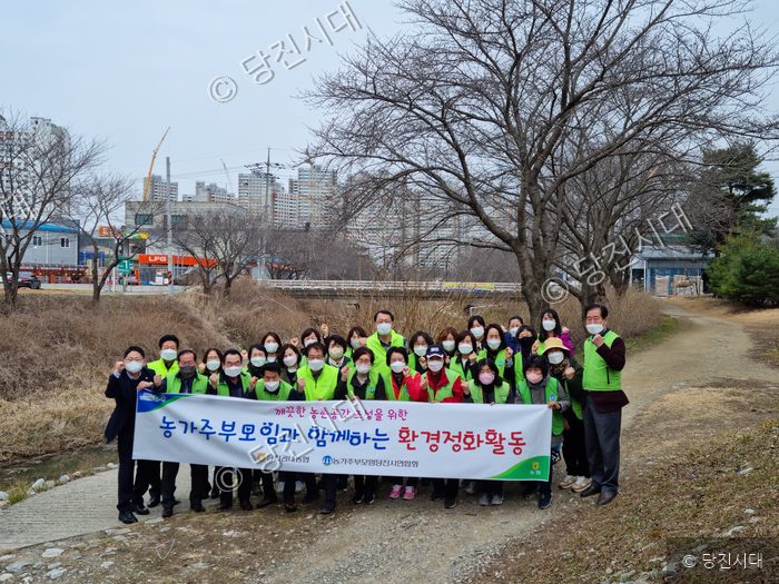당진의 농가주부모임 회원들이 환경정화 활동을 펼치며 기념촬영을 하고 있다.