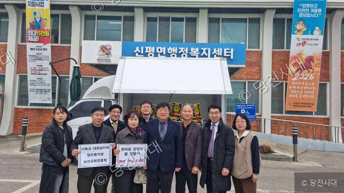신평면행정복지센터 앞에서 단체 이병섭 회장 등이 쌀 전달식을 하고 있다.