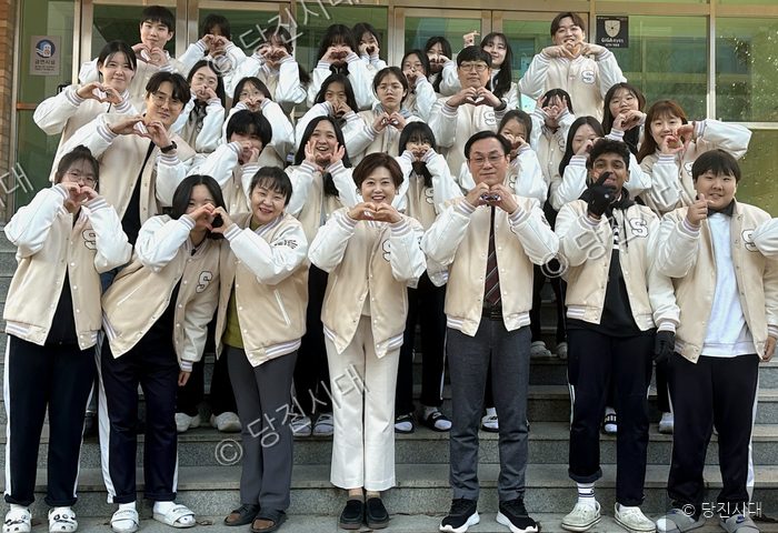 송악중학교 고희승 교장 등이 교사들과 함께 교문 앞에서 하트 포즈를 취하고 있다.