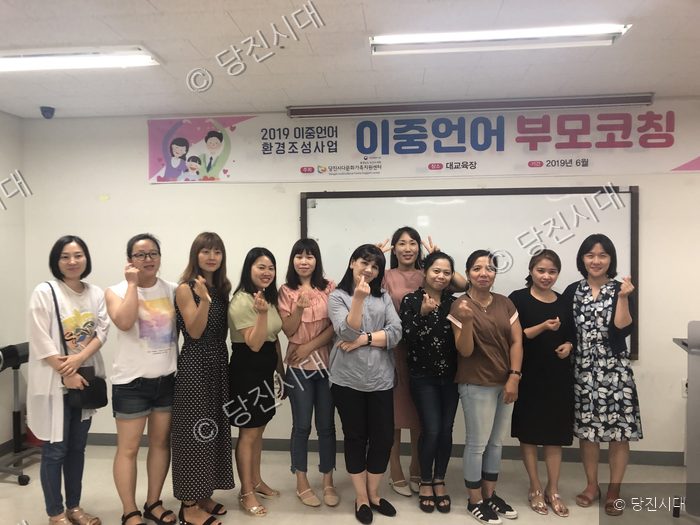 다문화가족지원센터에서 이중언어 부모코칭 교육 참여자들이 기념 촬영을 하고 있다.