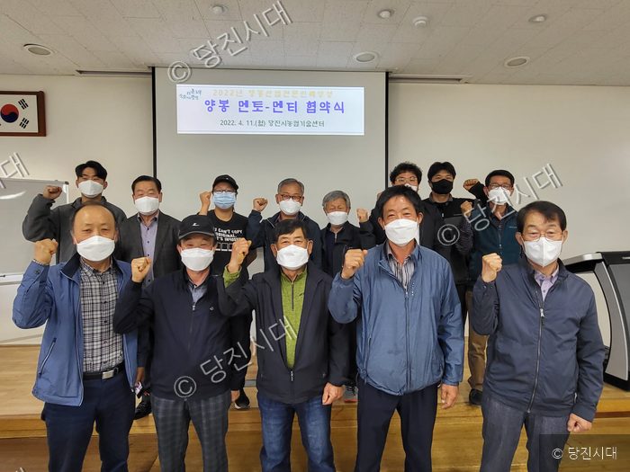 당진시에서 양봉 분야 멘토-멘티 협약식이 개최되어 참석자들이 기념 촬영을 하고 있다.