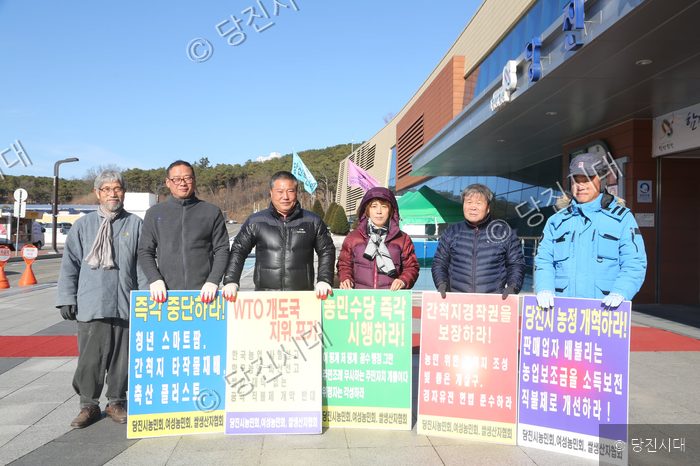 농민들이 피켓을 들고 농업정책 개혁을 요구하는 시위를 하고 있다.