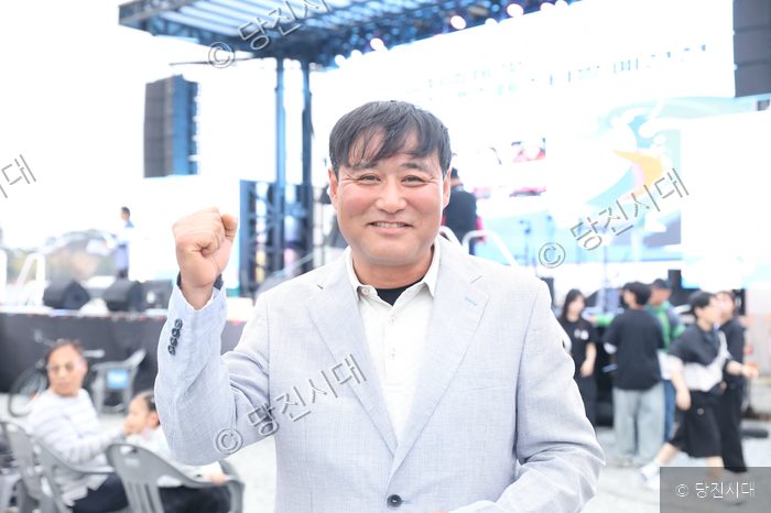 유문식 위원장이 행사장 무대 앞에서 주먹을 쥐고 파이팅을 외치고 있다.