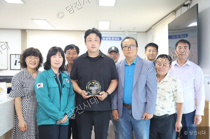 관계자들이 이병호 시설관리자에게 공로패를 수여하고 기념 촬영을 하고 있다.