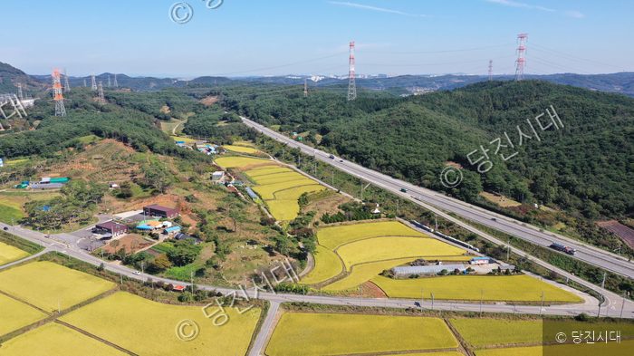 충남 당진시 정미면 사관리의 들판과 도로 풍경이 펼쳐져 있다.