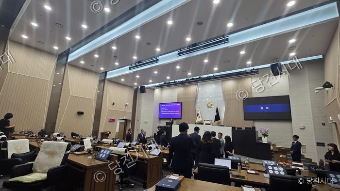 당진시의회 본회의장에서 의원들과 관계자들이 회의를 준비하고 있다.