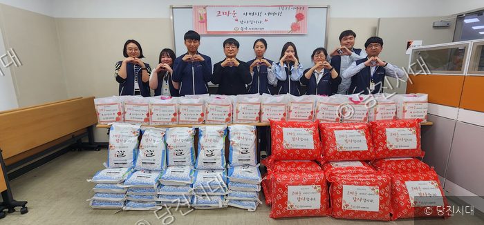 송악사회복지관 직원들이 어버이날을 맞아 후원 물품 앞에서 하트를 그리고 있다.